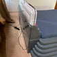 Portable heater on a stand in a room with a painting on the wall.