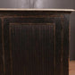 Dark wooden cabinet with a marble top against a dark background