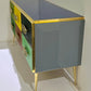Multicolored dresser with gold accents on a white background
