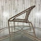 Wicker chair on a glass table against a wooden paneled wall