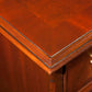 Close-up of a wooden desk with a gold handle