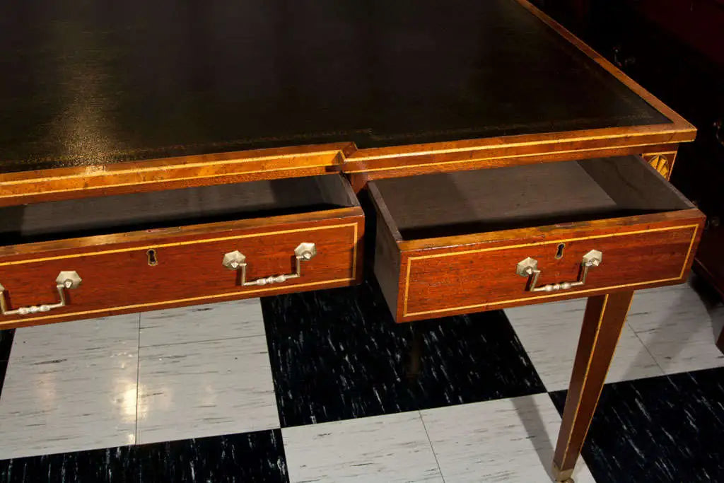 Wooden desk with two drawers on a checkered floor