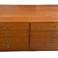 Wooden dresser with four drawers on a white background