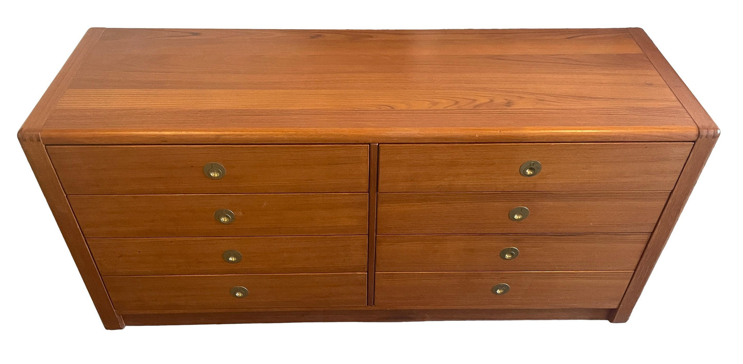 Wooden dresser with four drawers on a white background