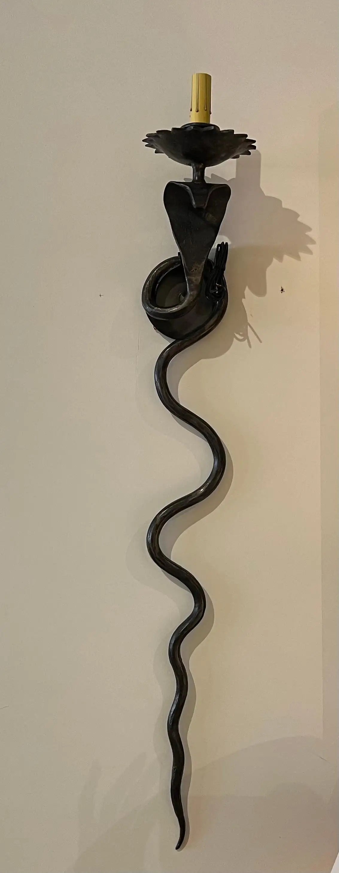 Pair of electrified Serpent Sconces finish in a gunmetal wrought iron finish