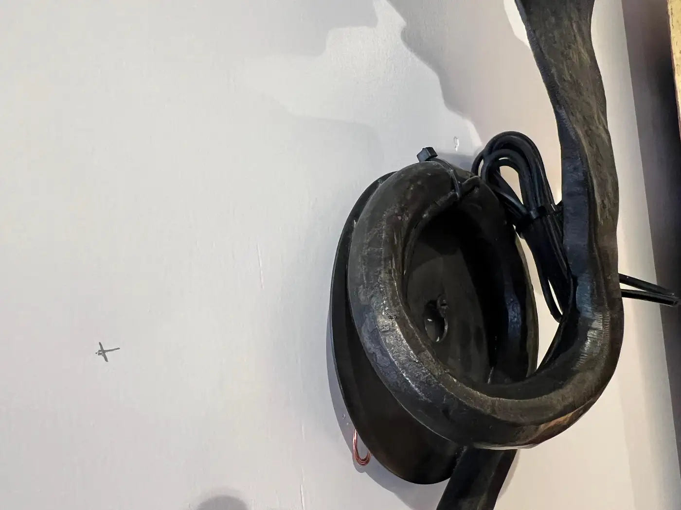 Pair of electrified Serpent Sconces finish in a gunmetal wrought iron finish