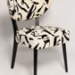 Chair with black and white abstract pattern on a light gray background