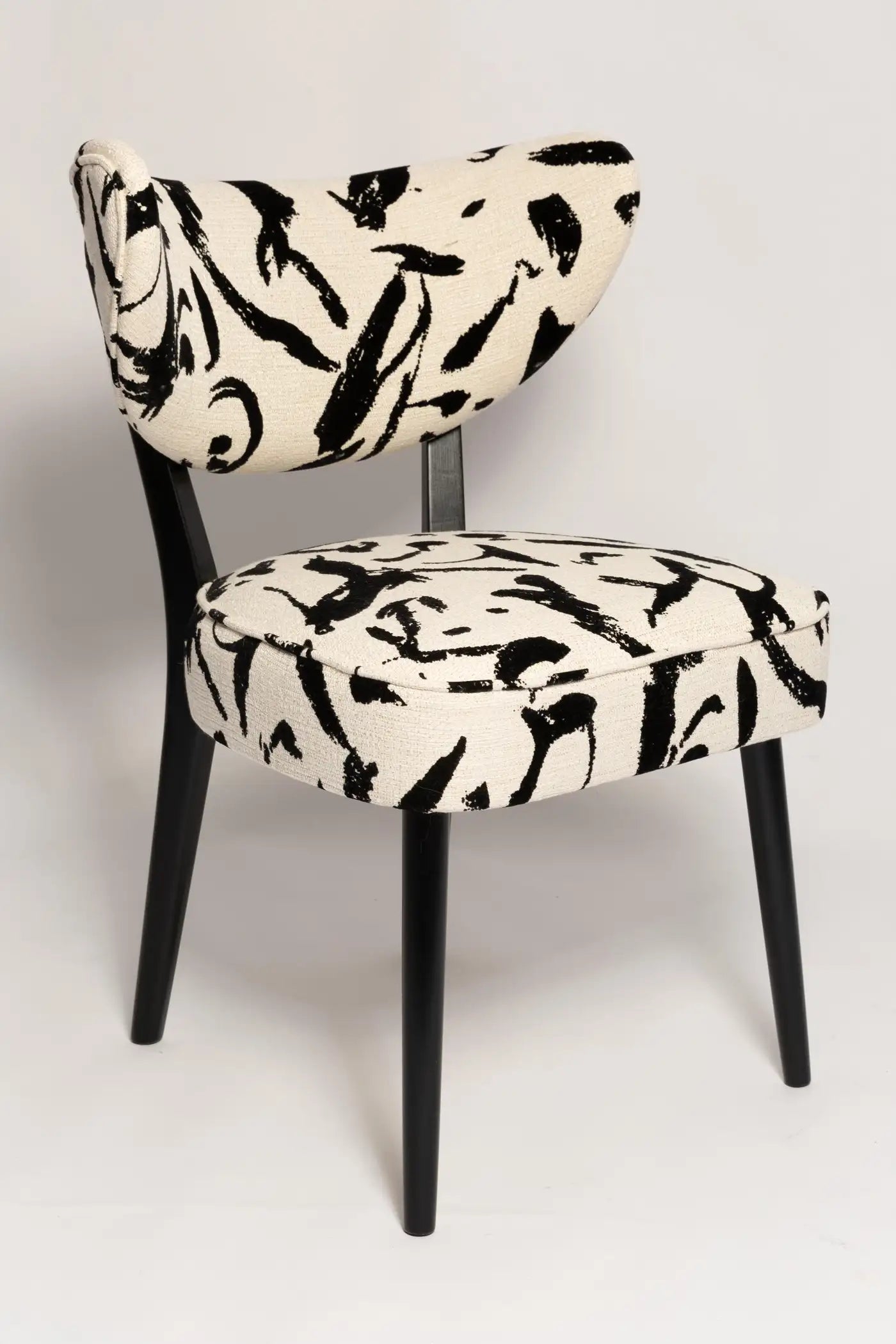 Chair with black and white abstract pattern on a light gray background