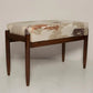 Wooden stool with patterned cushion on a white background