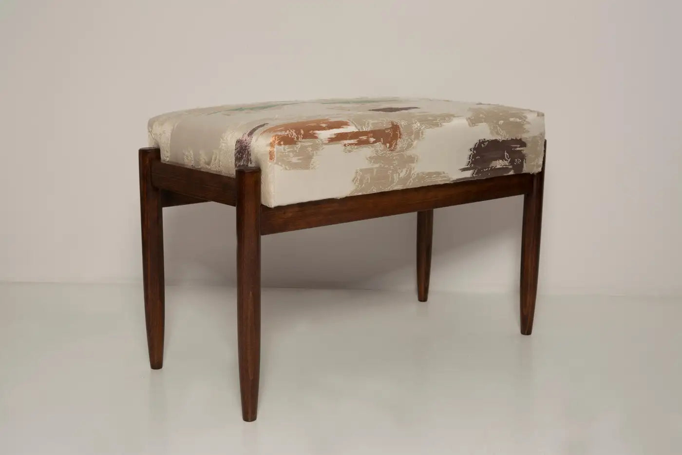 Wooden stool with patterned cushion on a white background