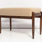 Wooden bench with beige cushion on a white background
