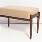 Wooden bench with beige cushion on a white background