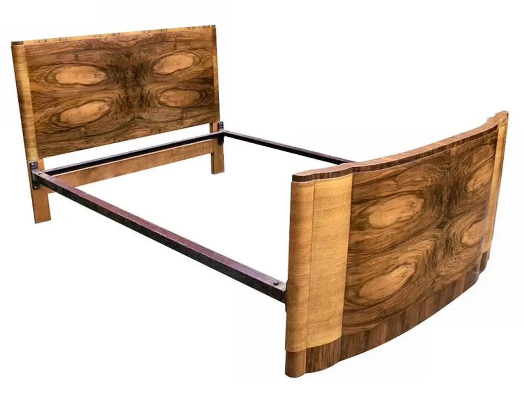 Wooden bed frame with curved design on a white background