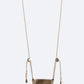 Brown woven swing hanging against a white background
