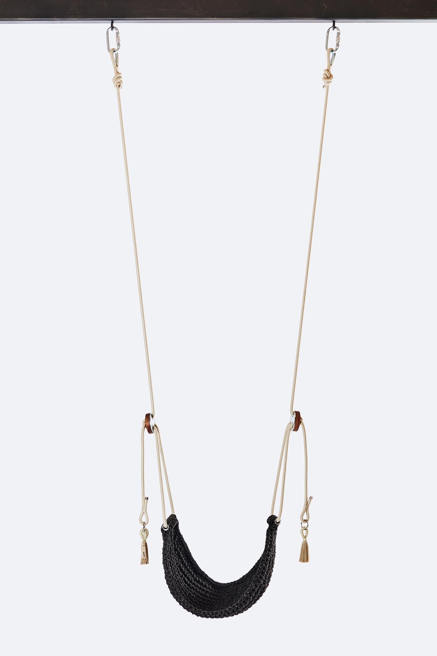 Black woven swing with beige chains on a white background