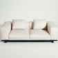 Beige sofa with black frame on a white background