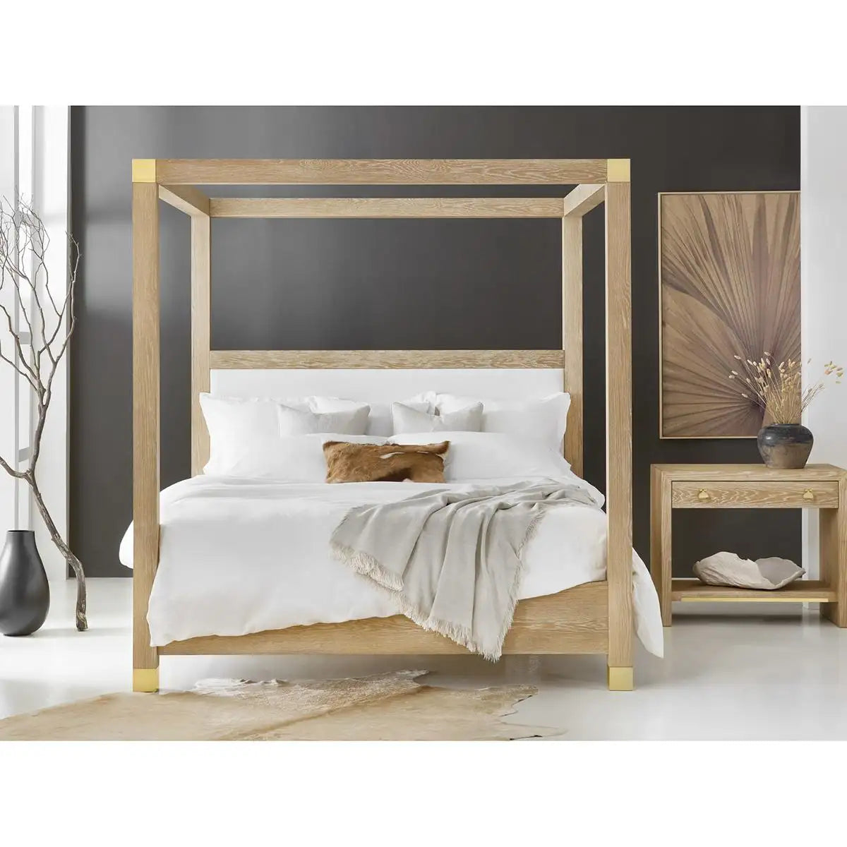Wooden canopy bed with white bedding in a bedroom setting.