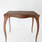 Wooden side table with a textured surface on a white background