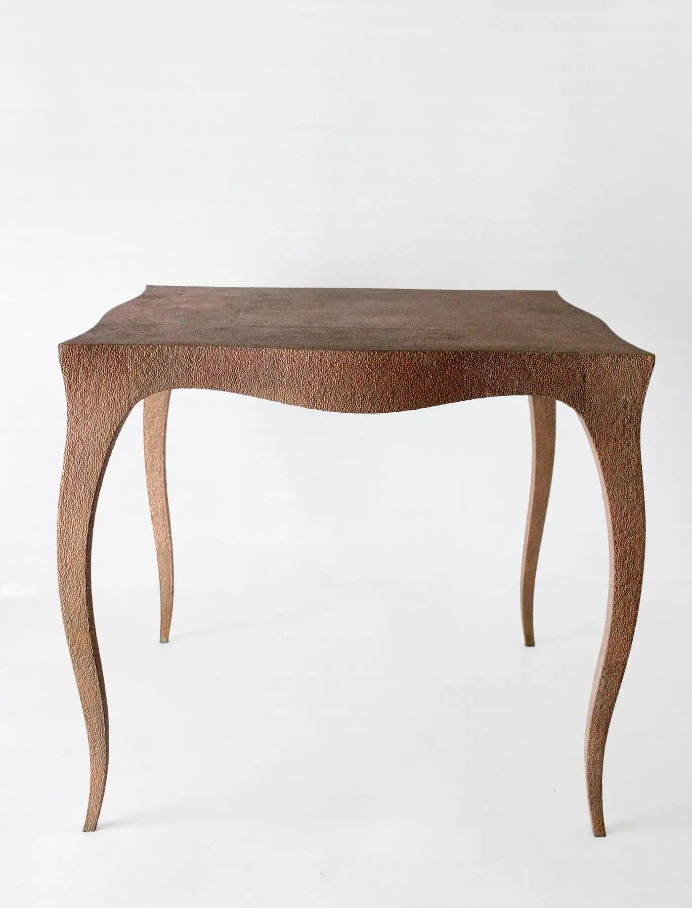 Wooden side table with a textured surface on a white background