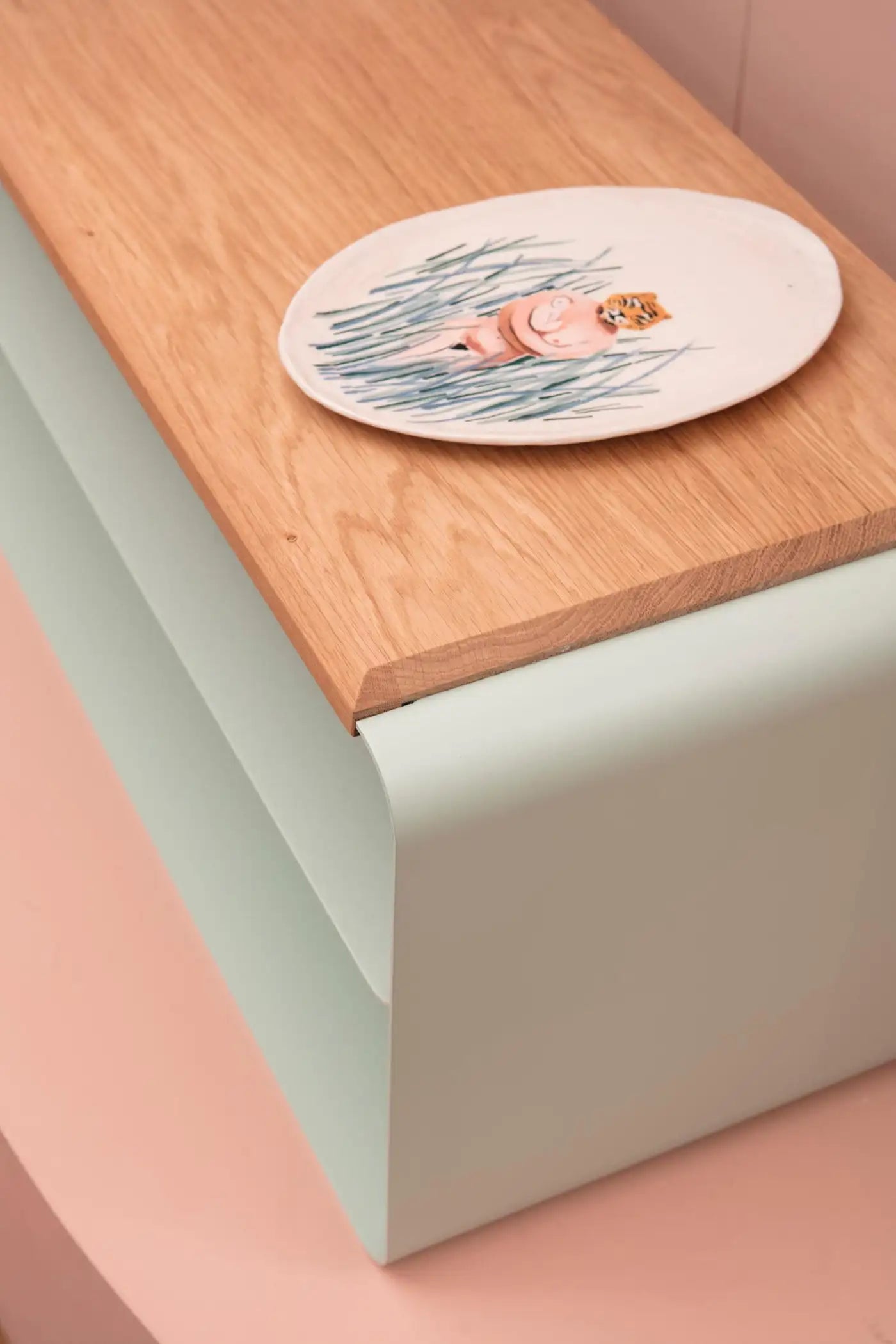 Round ceramic coaster with a design on a wooden surface