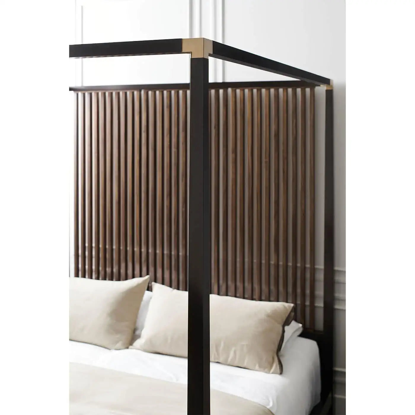 Bed with a wooden headboard in a bedroom setting