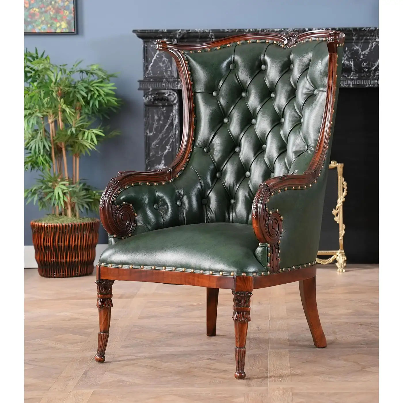 Green leather armchair with wooden frame in a room with a plant and fireplace.