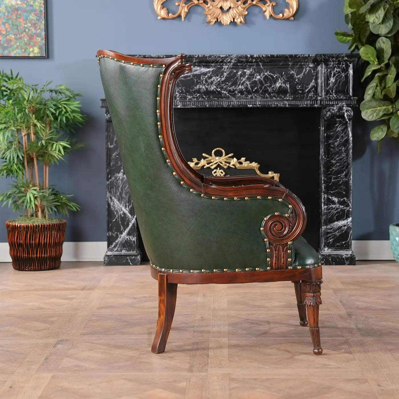Vintage green leather armchair with wooden frame in a room with marble fireplace and plants.