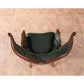 Green leather chair with wooden armrests on a wooden floor