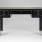 Black desk with gold accents on a gray background