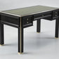 Black desk with glass top on a gray background