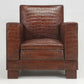 Brown leather armchair with crocodile texture on a white background