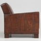 Brown leather armchair with crocodile texture on a white background