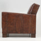 Brown leather armchair with a textured pattern on a white background
