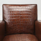 Brown crocodile-patterned leather armchair on a white background