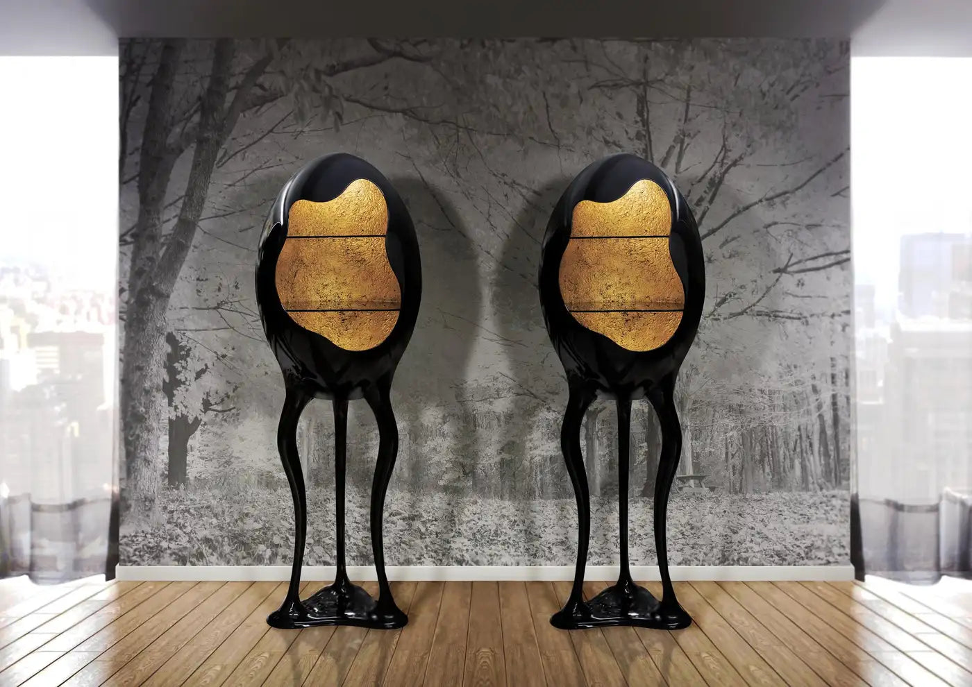 Two unique black and gold sculptures on a wooden floor with a textured wall in the background.