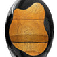 Black and gold decorative object with a textured surface