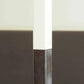 Close-up of a sword with a brown handle and white blade against a blurred background