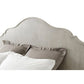 Beige upholstered headboard with pillows on a white background