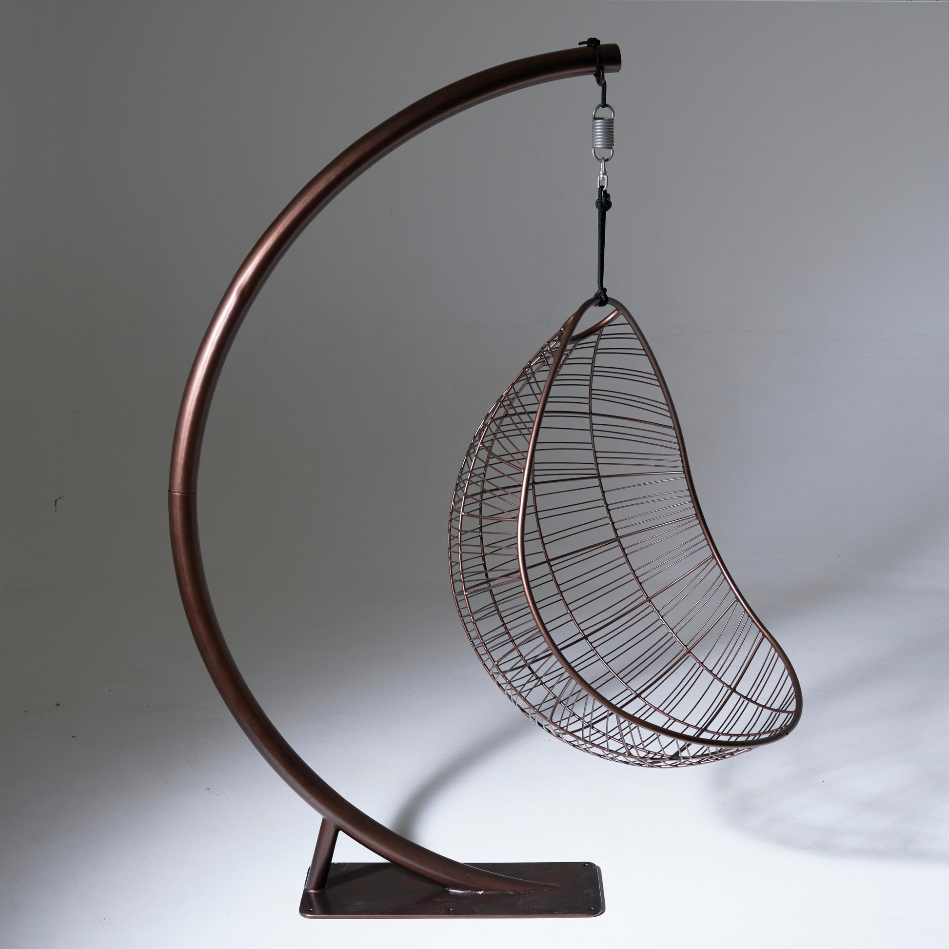 Hanging chair with metal stand on a gray background