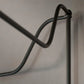 Metallic wall-mounted rack on a plain wall