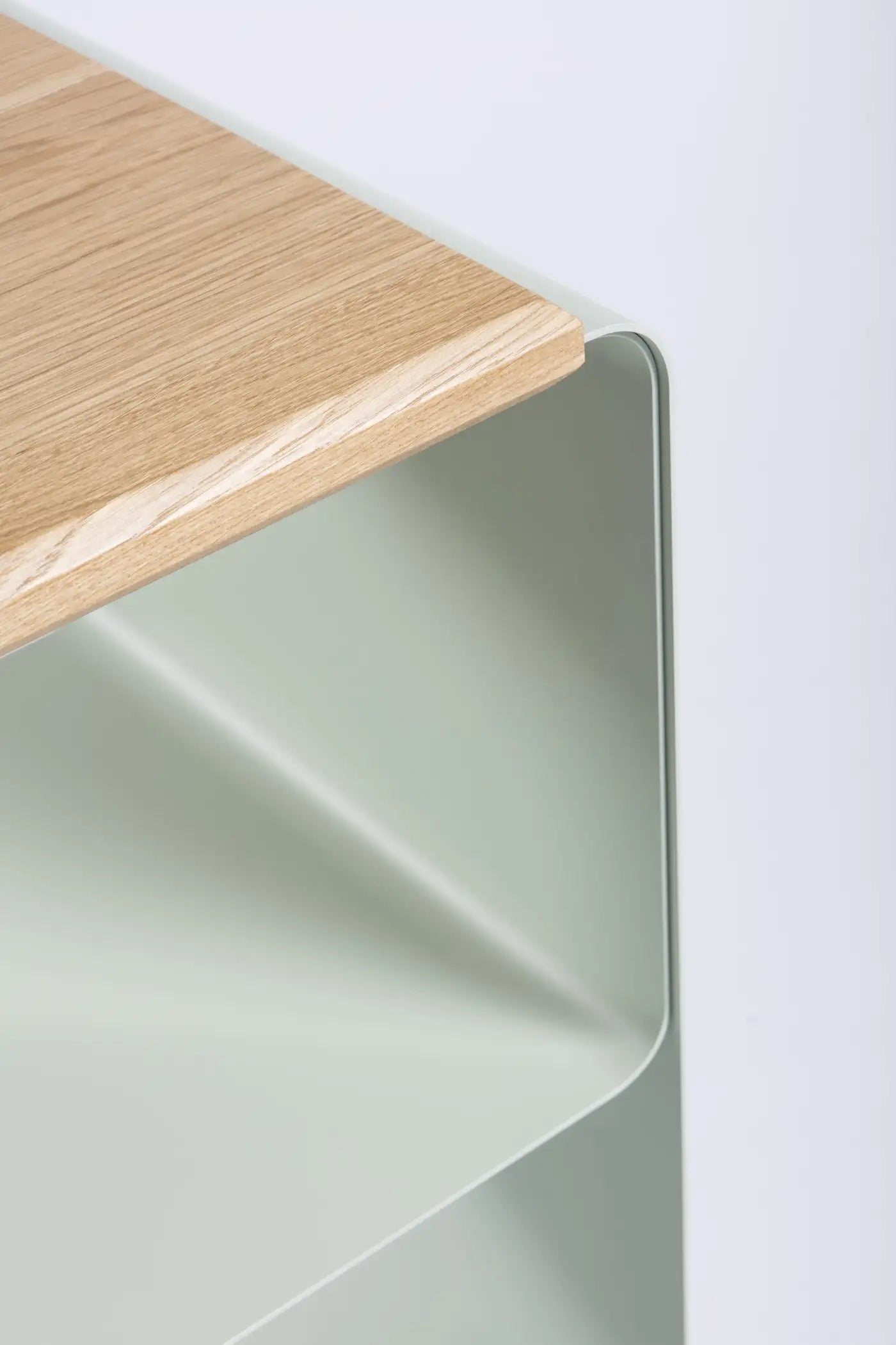 Wooden shelf against a white wall