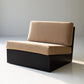 Modern black and beige sofa against a plain wall