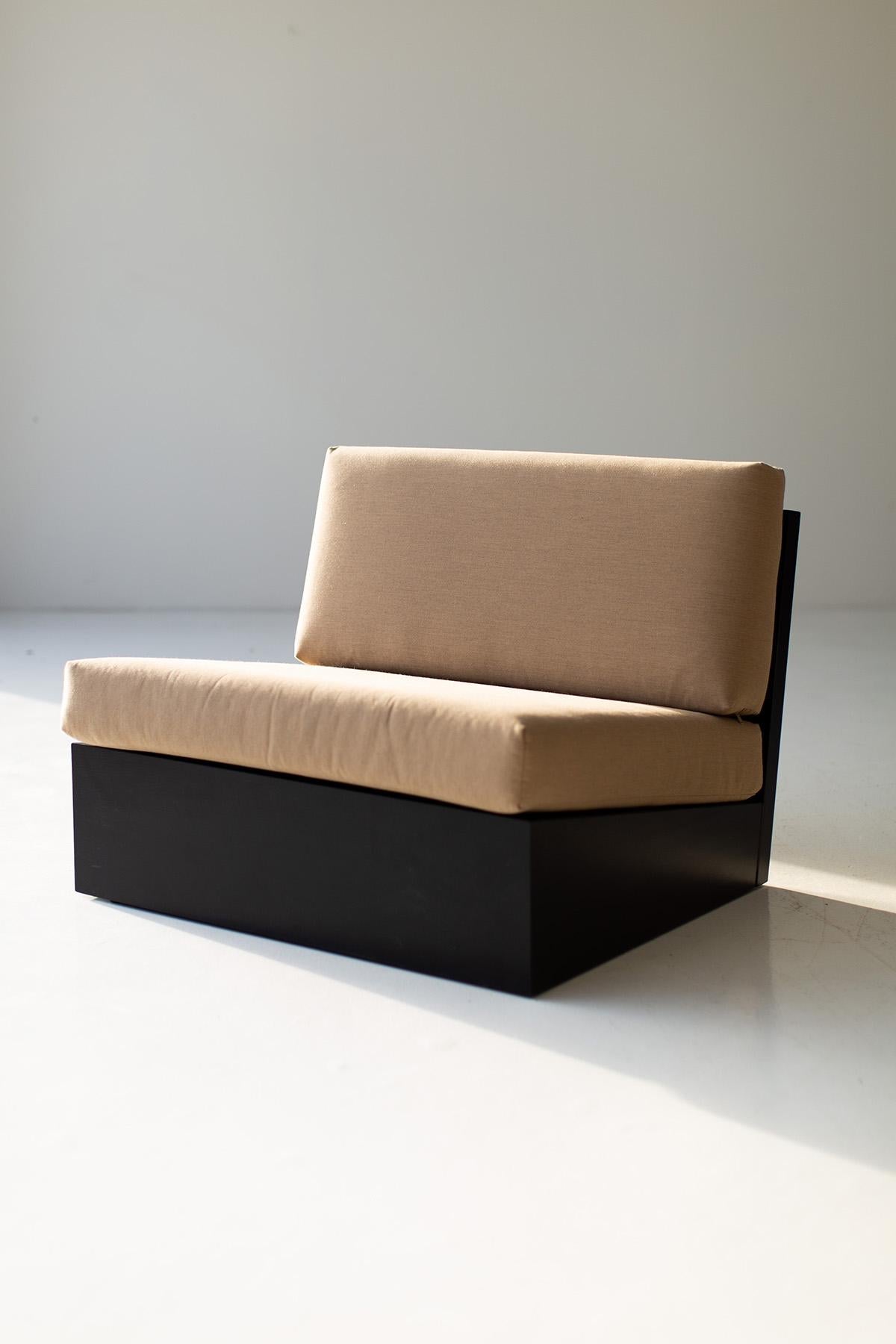 Modern black and beige sofa against a plain wall