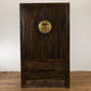 Wooden wardrobe with circular emblem on a white brick wall background