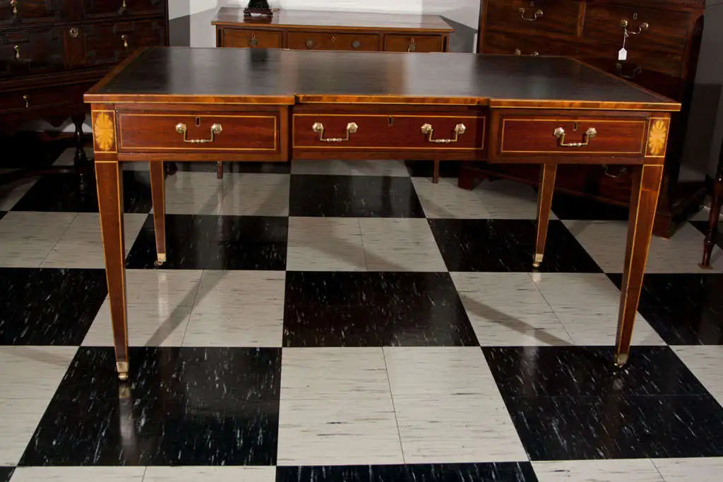 Wooden desk with drawers on a black and white checkered floor