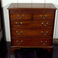 Wooden dresser with multiple drawers in a room setting