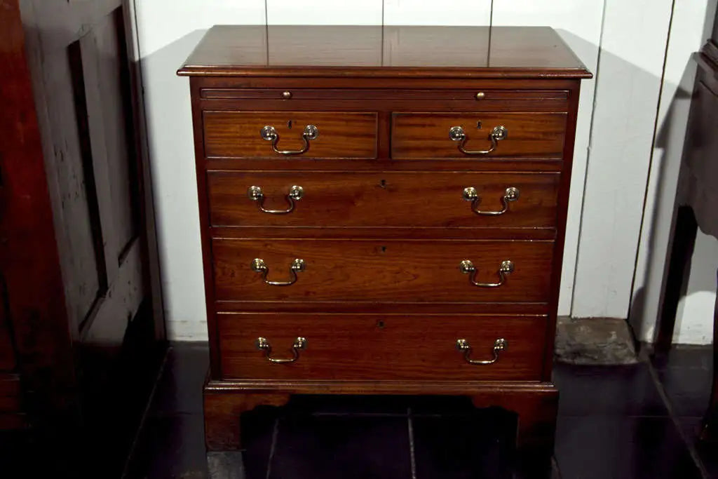 Wooden dresser with multiple drawers in a room setting