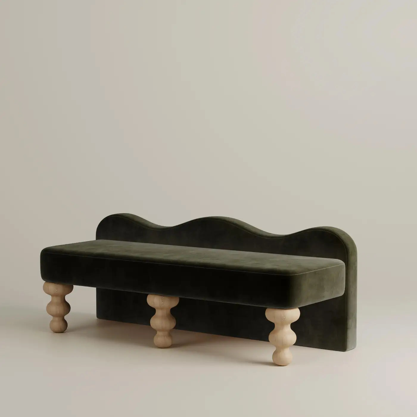 Green velvet bench with wooden legs on a beige background