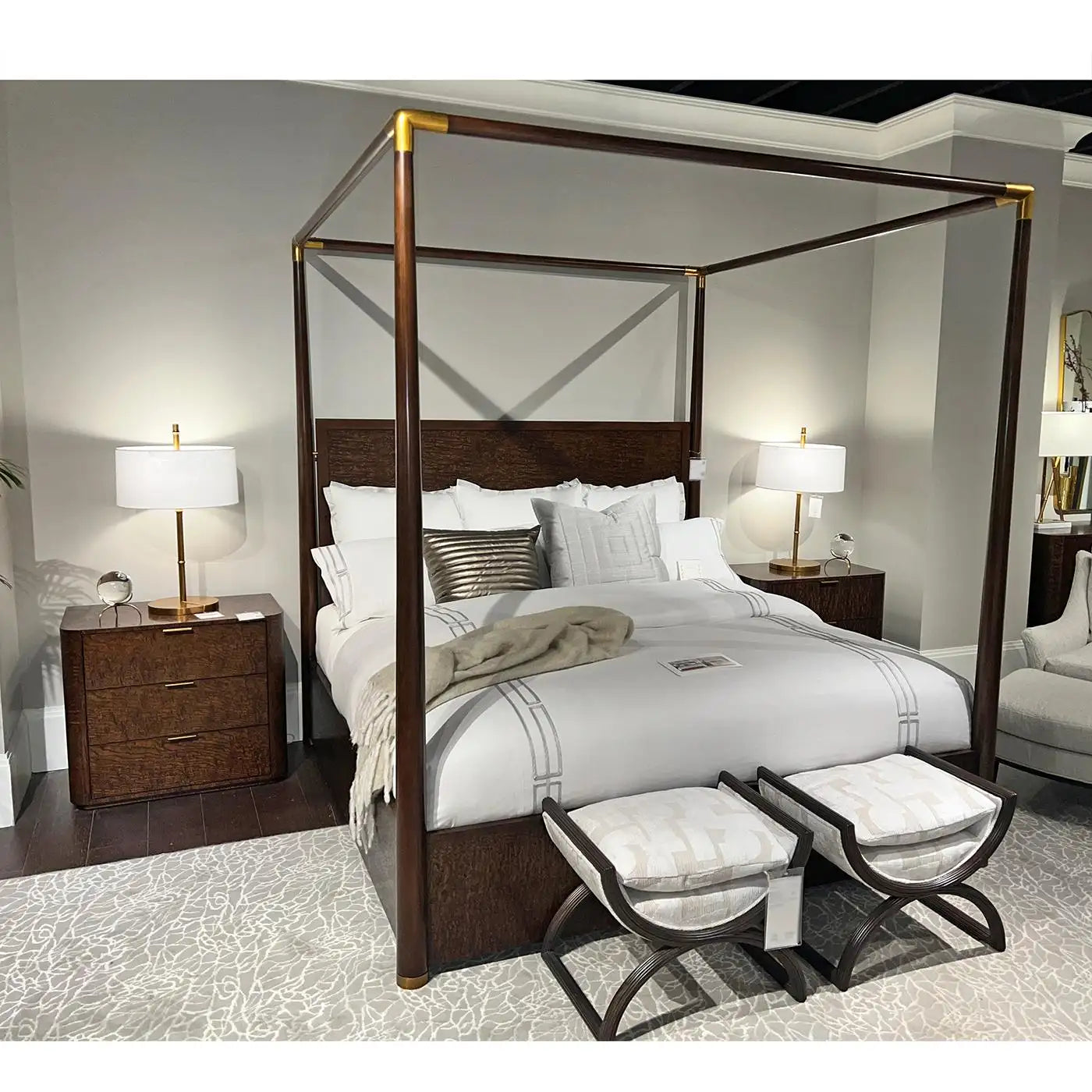 Bedroom with a four-poster bed, nightstands, and ottomans.