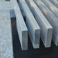 Metal rectangular bars on a textured surface